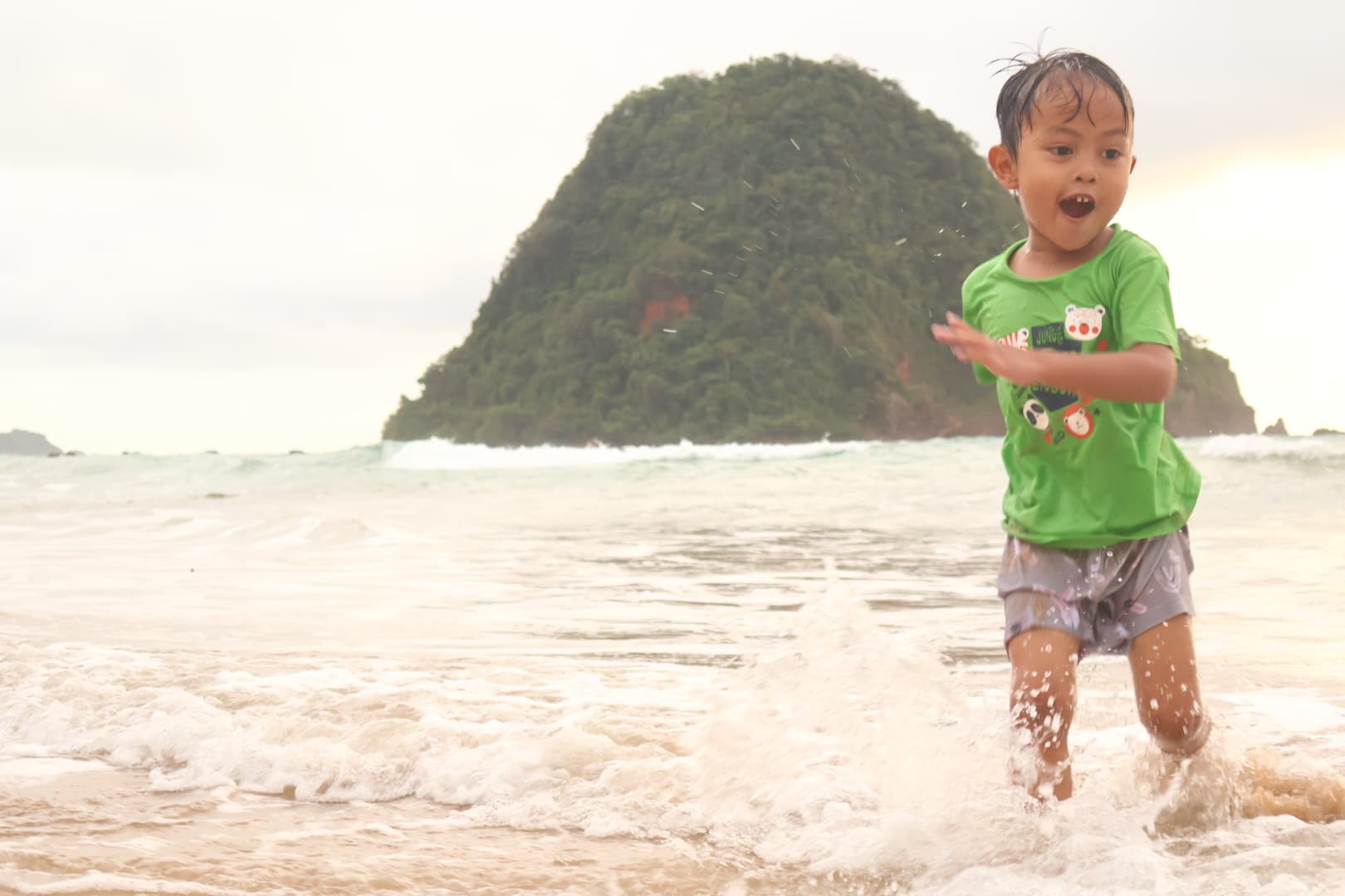 Anak-anak bermain di tepi air jernih Pulau Tabuhan